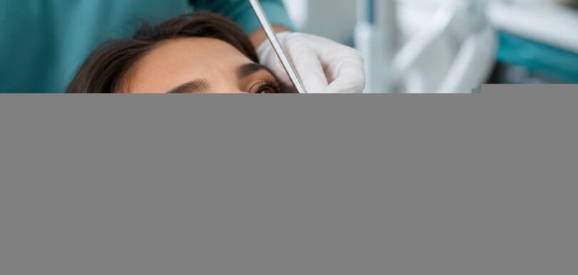Dentist examining a patient's teeth at Ethos Hospital, Kota